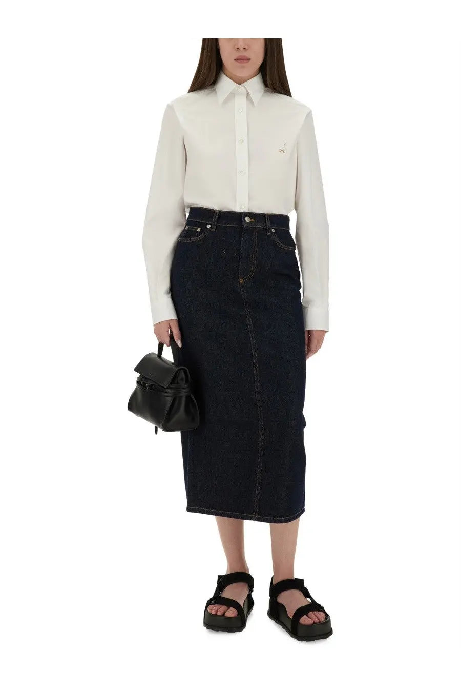 Dark blue denim midi skirt with front seam and button closure styled with moschino women’s white shirt