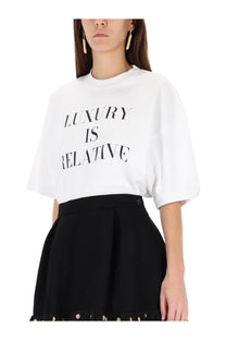 Moschino women’s white oversized t-shirt with black luxury is relative text printed across the chest
