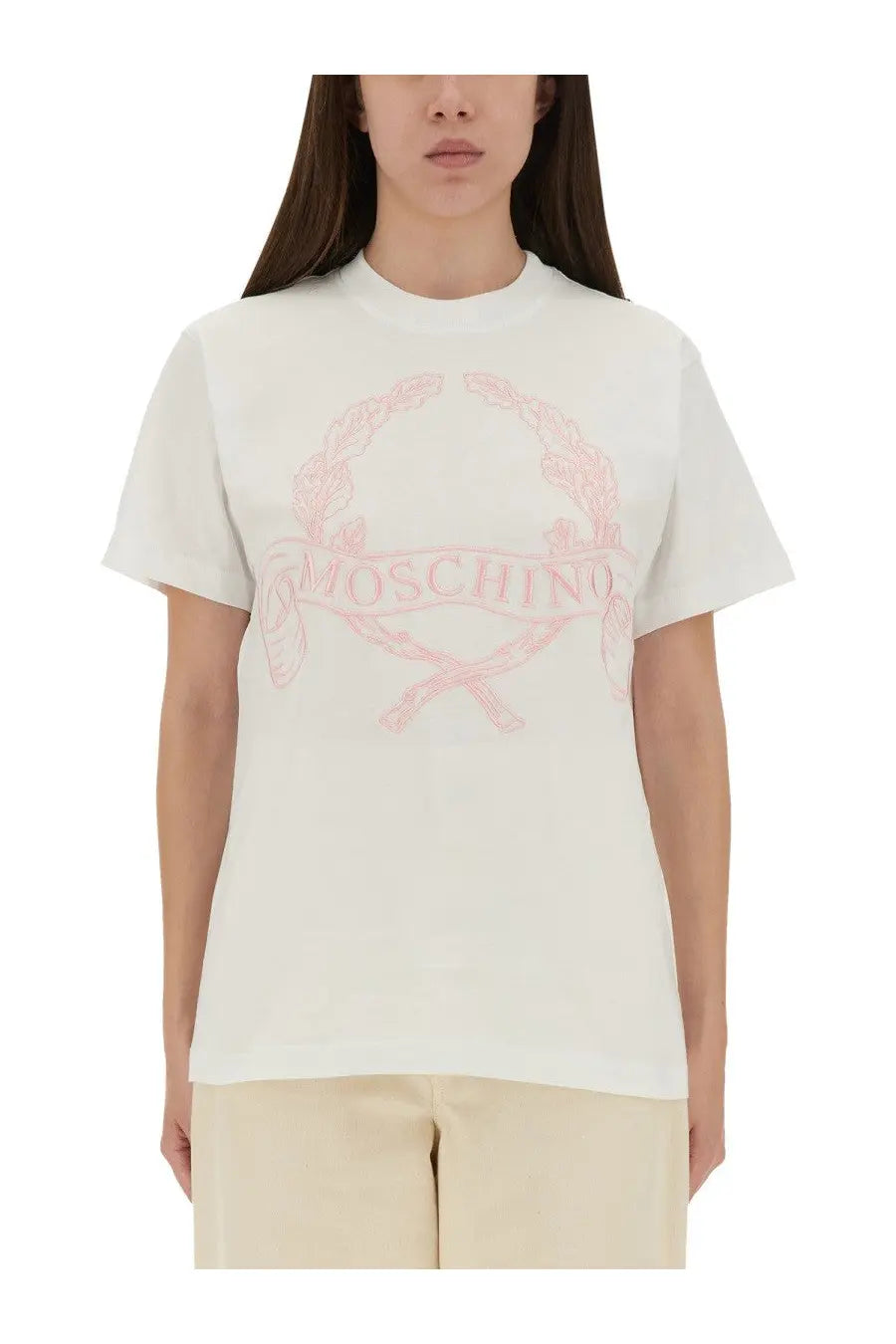 Moschino women shirt white featuring delicate pink embroidered logo with crossed swords and laurel wreath design