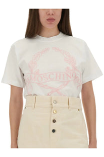 Moschino women’s white t-shirt with pink embroidered logo and laurel wreath design on front