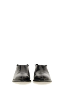 Moschino women’s shootie cuban heel black leather mules with glossy finish and scalloped edges