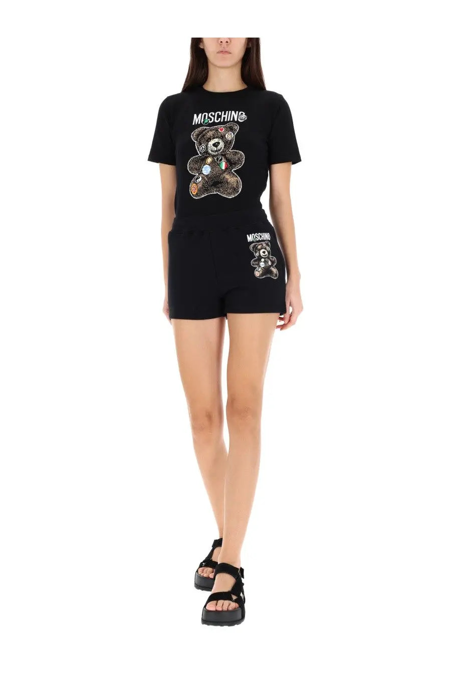 Moschino women’s black t-shirt and shorts set featuring a sequined teddy bear graphic with colorful patches and logo