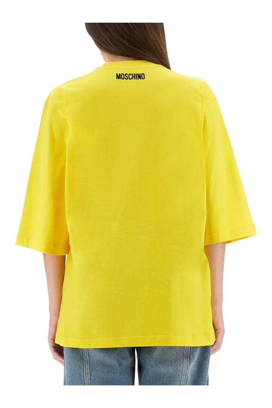Bright yellow Moschino women’s oversized t-shirt with black logo at the neckline perfect for casual wear