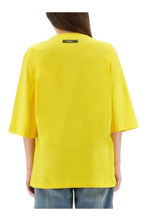 Bright yellow Moschino women’s oversized t-shirt with black logo at the neckline perfect for casual wear