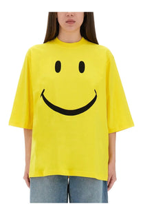 Moschino women’s bright yellow oversized t-shirt with bold black smiley face graphic on soft cotton fabric