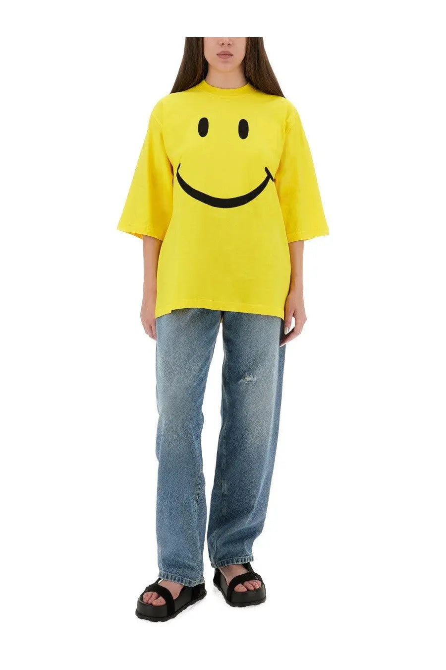 Moschino women’s bright yellow oversized t-shirt with bold black smiley face graphic for casual wear
