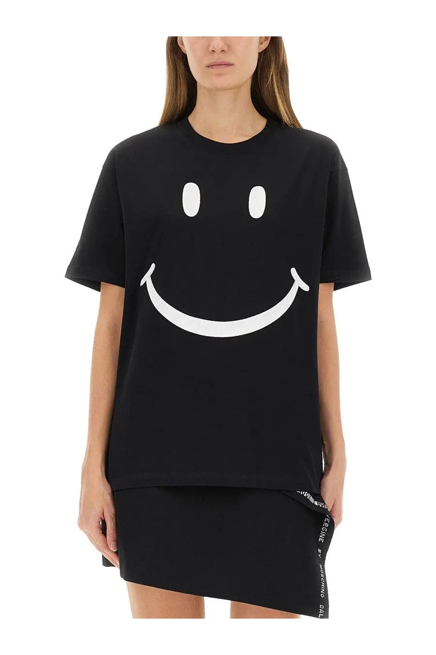Moschino women’s black oversized t shirt made of cotton featuring a bold white smiley face graphic on the front