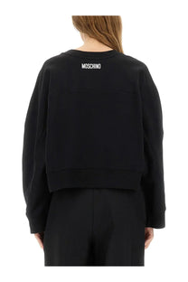 Moschino women’s black sweatshirt with white smiley logo on the back made from soft cotton blend