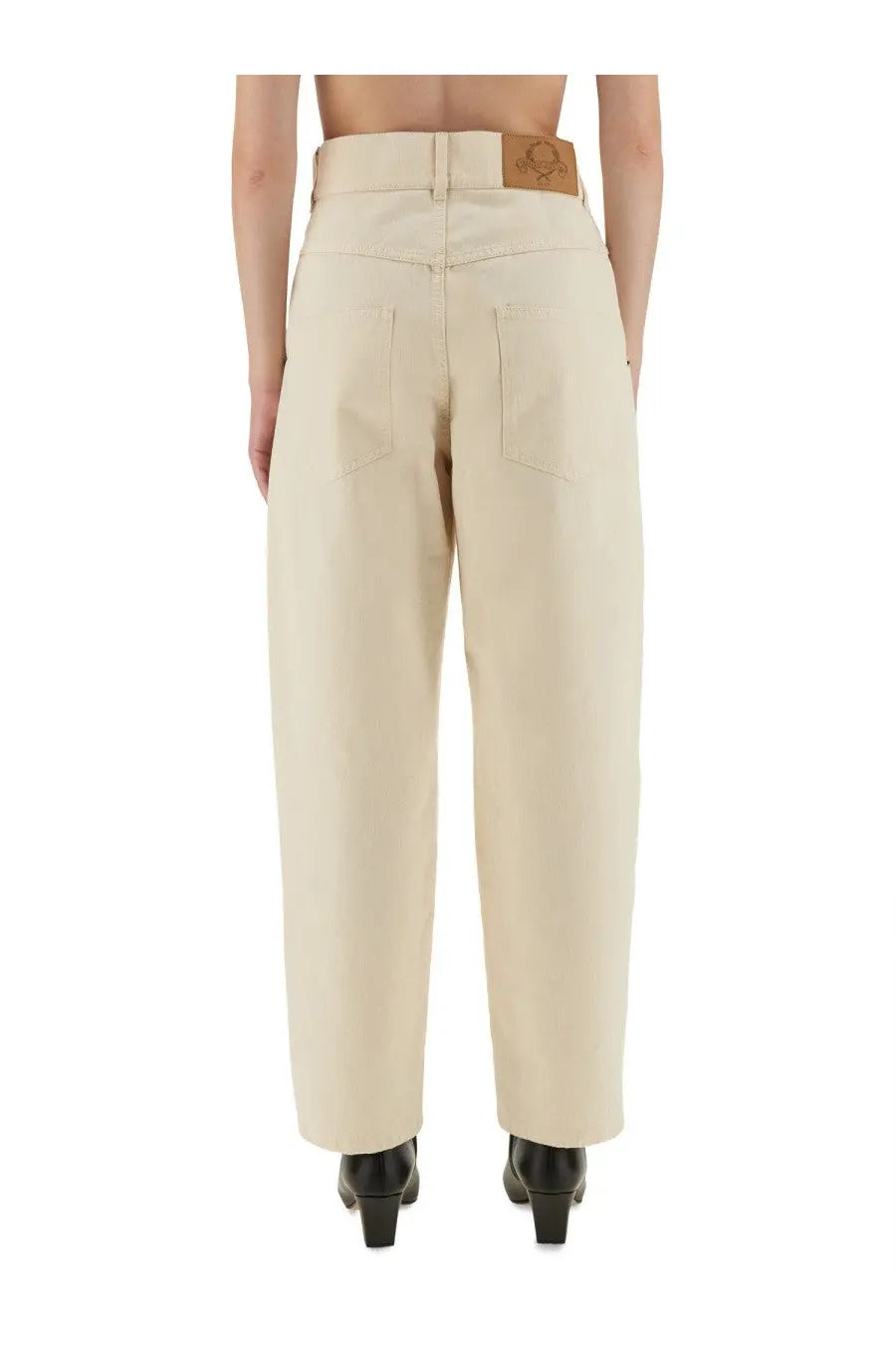 Beige moschino women’s high-waisted wide-leg trousers with a leather brand patch at the waistband back view