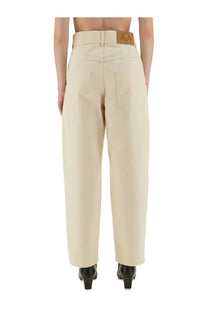 Beige moschino women’s high-waisted wide-leg trousers with a leather brand patch at the waistband back view