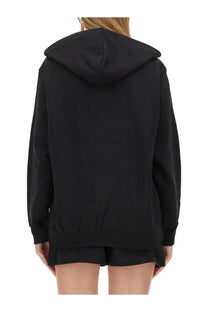 Moschino women’s black oversized hoodie with relaxed fit and ribbed cuffs made of soft sweat fabric