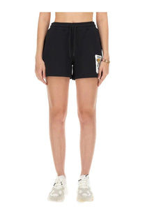 Moschino women’s black cotton sweatshirt shorts with drawstring waistband and white embroidered patch on left leg