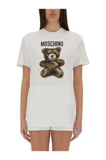 Moschino women’s white cotton t-shirt featuring a brown teddy bear graphic with the brand name above it