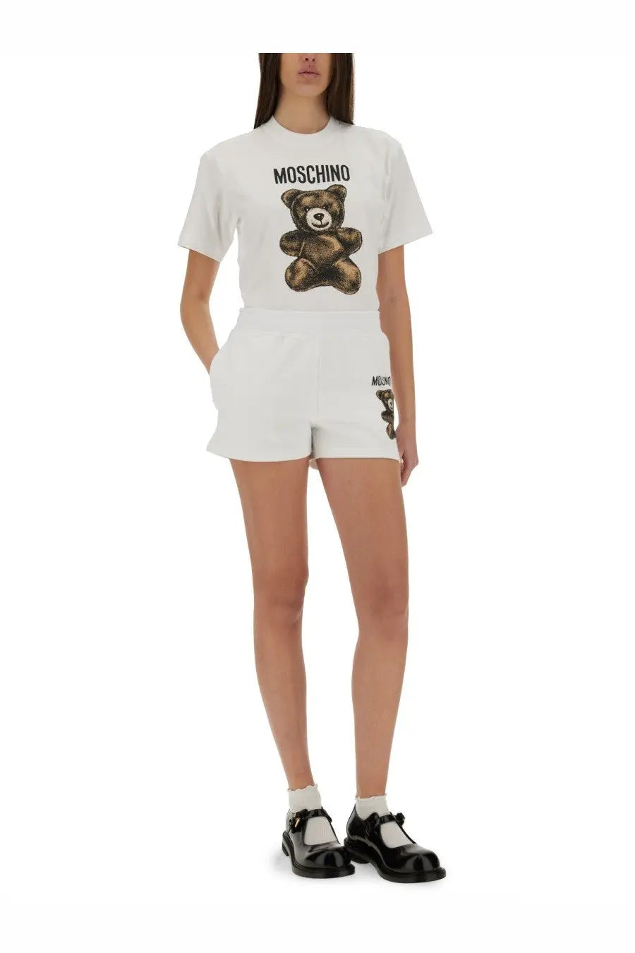 Moschino women’s white t-shirt featuring a brown teddy bear graphic with the brand name printed above