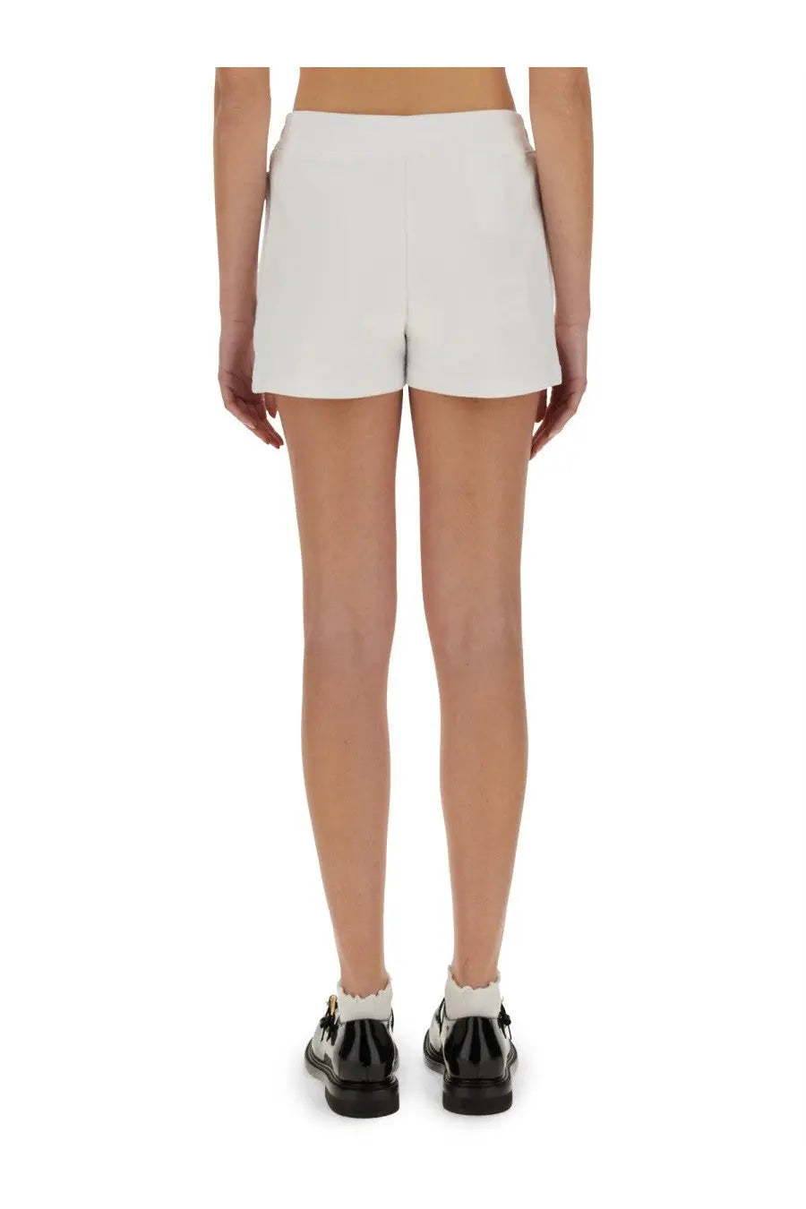 White tailored shorts by moschino with a clean minimalist design featuring teddy bear detailing