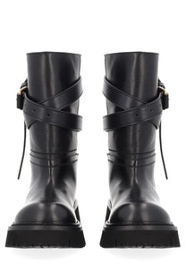Black leather ankle boots with crisscross straps and gold-tone buckles by Moschino women tie me boot black