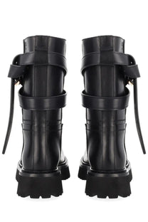 Moschino women’s tie me boot black leather combat boots with multiple straps and chunky soles