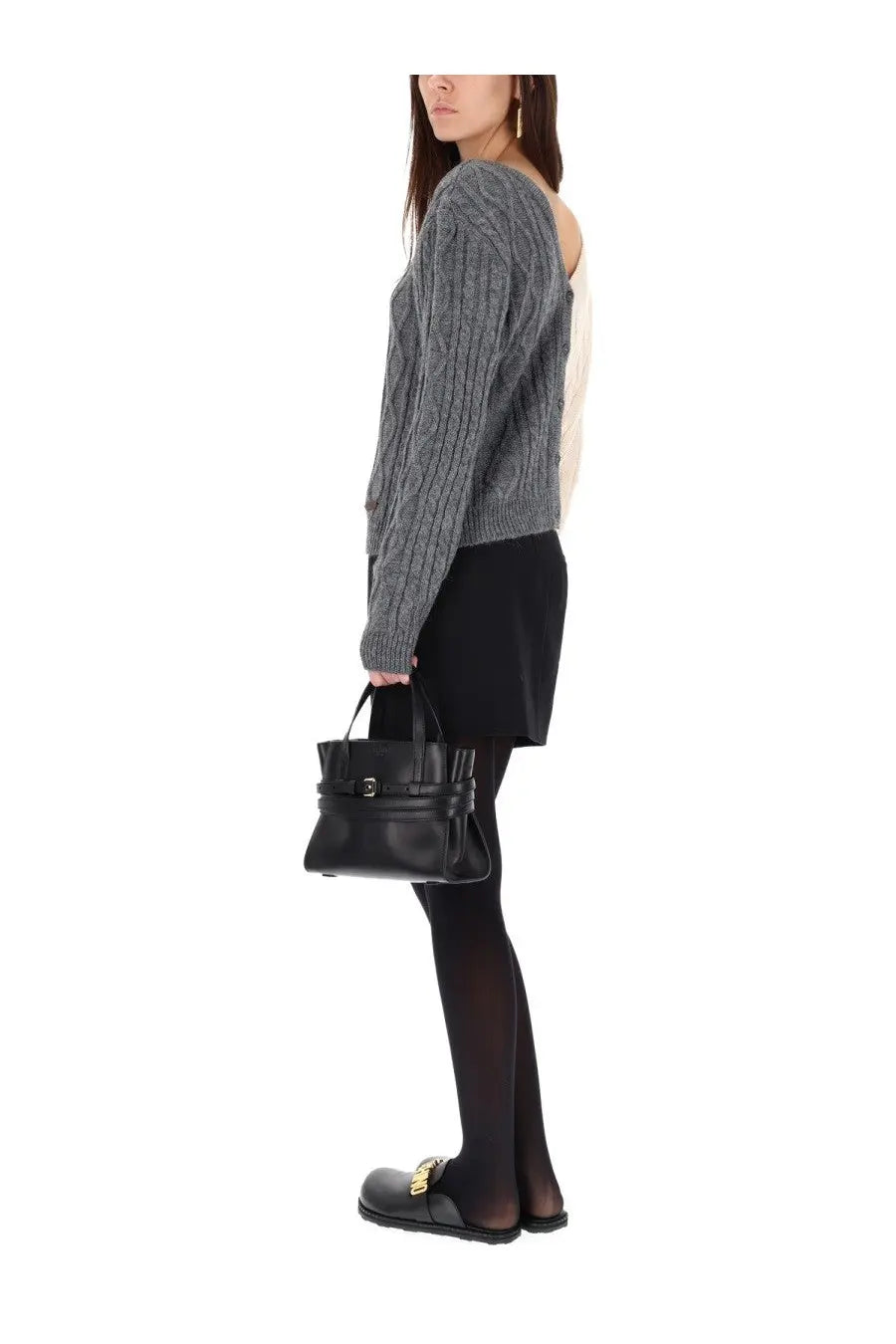 Black leather handbag with structured design and gold tone hardware paired with moschino women’s two tone grey cardigan