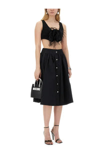 Black moschino shopping bag with white handles and bold white lettering featured with moschino women’s vests black