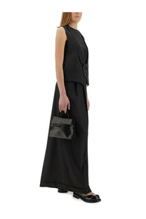 Black leather mini handbag with top handle and front flap closure complementing moschino women’s virgin wool vest black