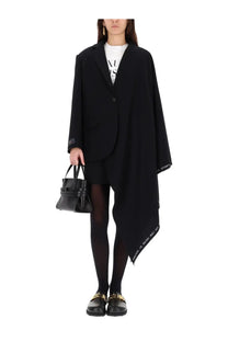 Black oversized Moschino women’s wool flannel blazer with asymmetrical hem and subtle branding along edges