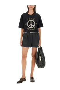 Black moschino leather tote bag with gold lettering and zipper closure paired with grey wool shorts for women