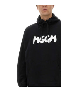 Black oversized MSGM men’s hoodie with white brush stroke logo on chest made from comfortable material