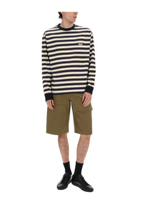 Black and white striped long-sleeved sweater with navy ribbed crew neck cuffs and hem paired with msgm men’s green cotton shorts