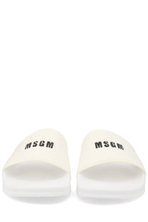 Cream-colored MSGM men’s slide sandals with black logo branding ideal for casual summer wear
