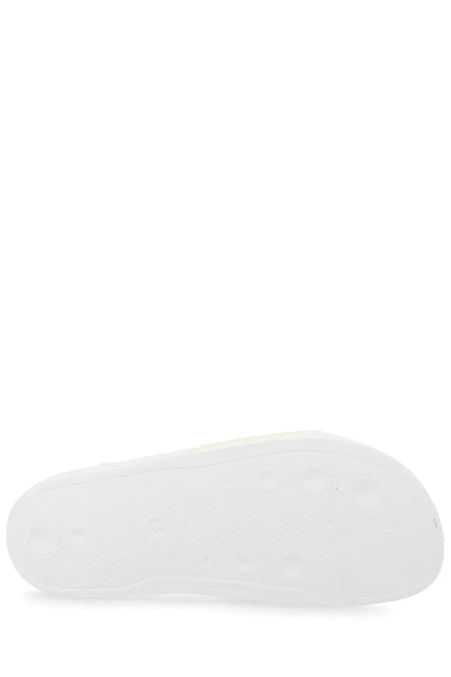 White rubber sole of msgm men’s slide con white with smooth textured surface and subtle circular indentations visible