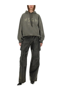 Olive green msgm hoodie with milano print across the chest paired with black womens cargo pants