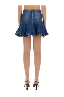 Msgm women’s blue denim skirt with flared ruffled hem and central back zipper shown from the back side