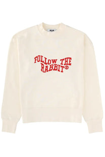 Cream-colored msgm women’s sweatshirt with bold red follow the rabbit lettering across the chest