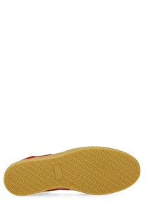 Msgm women’s retro sneaker red featuring a red high-top design with tan rubber sole and diamond-patterned tread