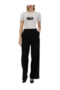 White ribbed short-sleeved women’s shirt with black msgm logo across the chest made from soft fabric