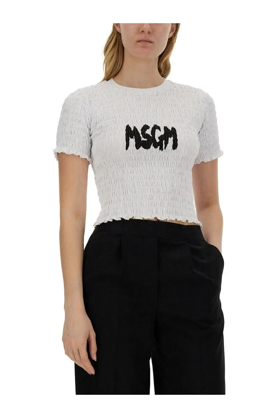 White smocked short-sleeved crop top from MSGM with black logo embroidery across the chest for women