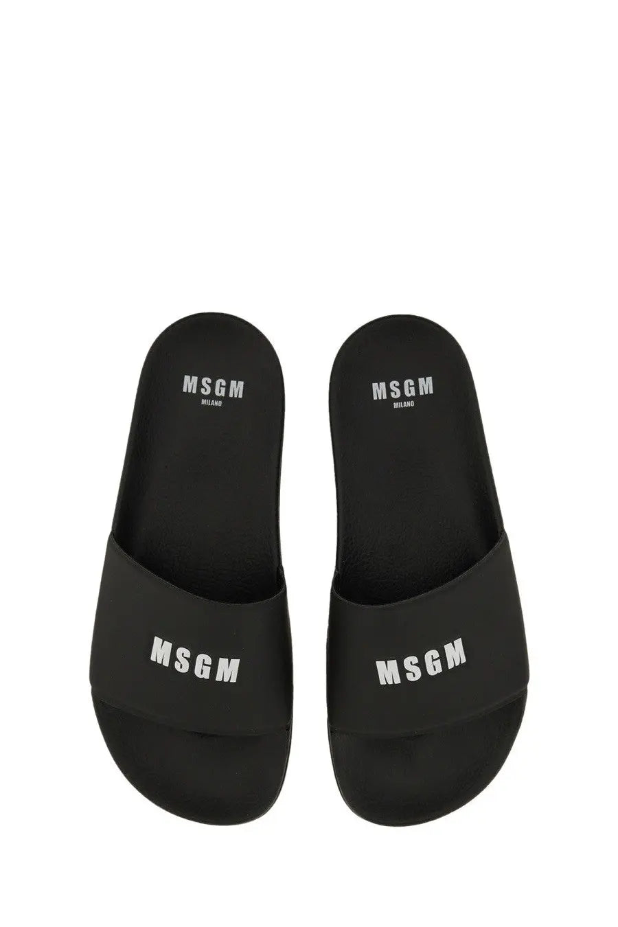 Black msgm women’s slide sandals with white logo branding on the footbed and strap for casual wear