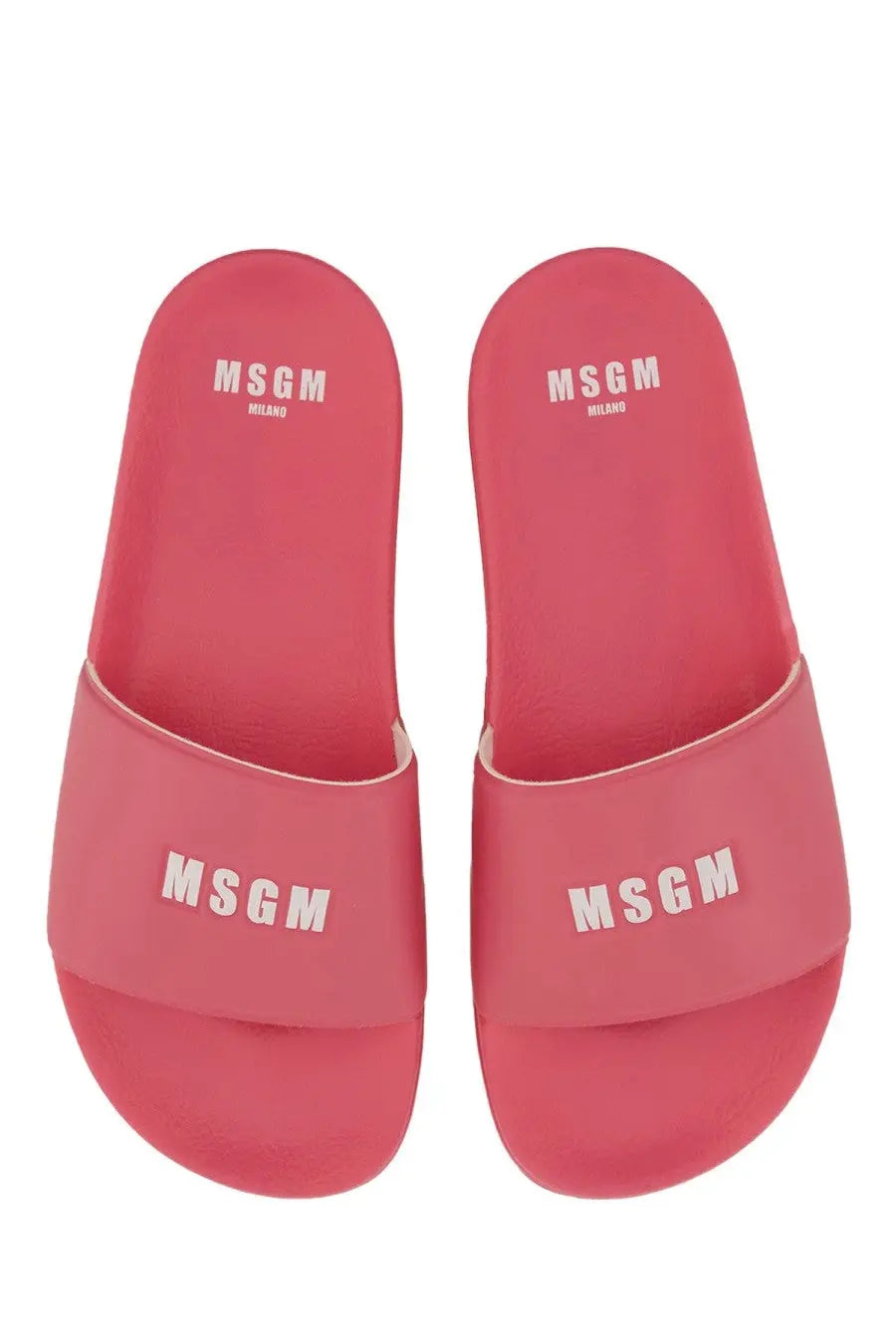 Pair of vibrant pink MSGM women’s slide sandals featuring bold white logo branding on the upper strap