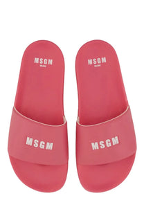 Pair of vibrant pink MSGM women’s slide sandals featuring bold white logo branding on the upper strap