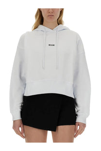 White cropped hoodie with black msgm logo on chest and ribbed hem in msgm women’s sweatshirt white