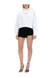 Msgm women’s white oversized hoodie with subtle black logo on chest made from soft cotton sweatshirt material