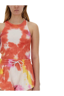 A vibrant tie dye tank top in orange pink and white with ribbed texture and msgm logo on the chest for women