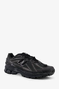 New Balance men’s Gore Tex black 1080r running shoe with mesh upper and subtle gray branding details