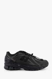 New Balance men’s Gore Tex black 1906r running shoe with mesh and synthetic overlays and gray stitching details