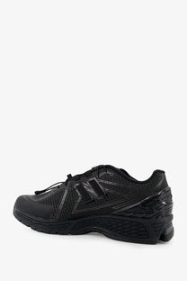 New Balance men’s Gore Tex black running shoe with mesh and synthetic overlays and subtle reflective accents