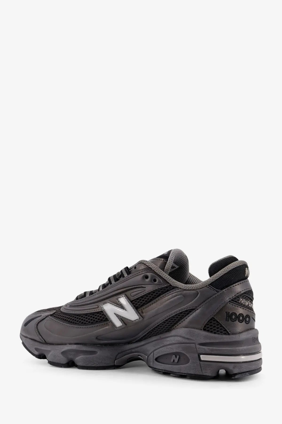New Balance men’s low top black sneaker with dark gray mesh and synthetic leather upper and white branding accents