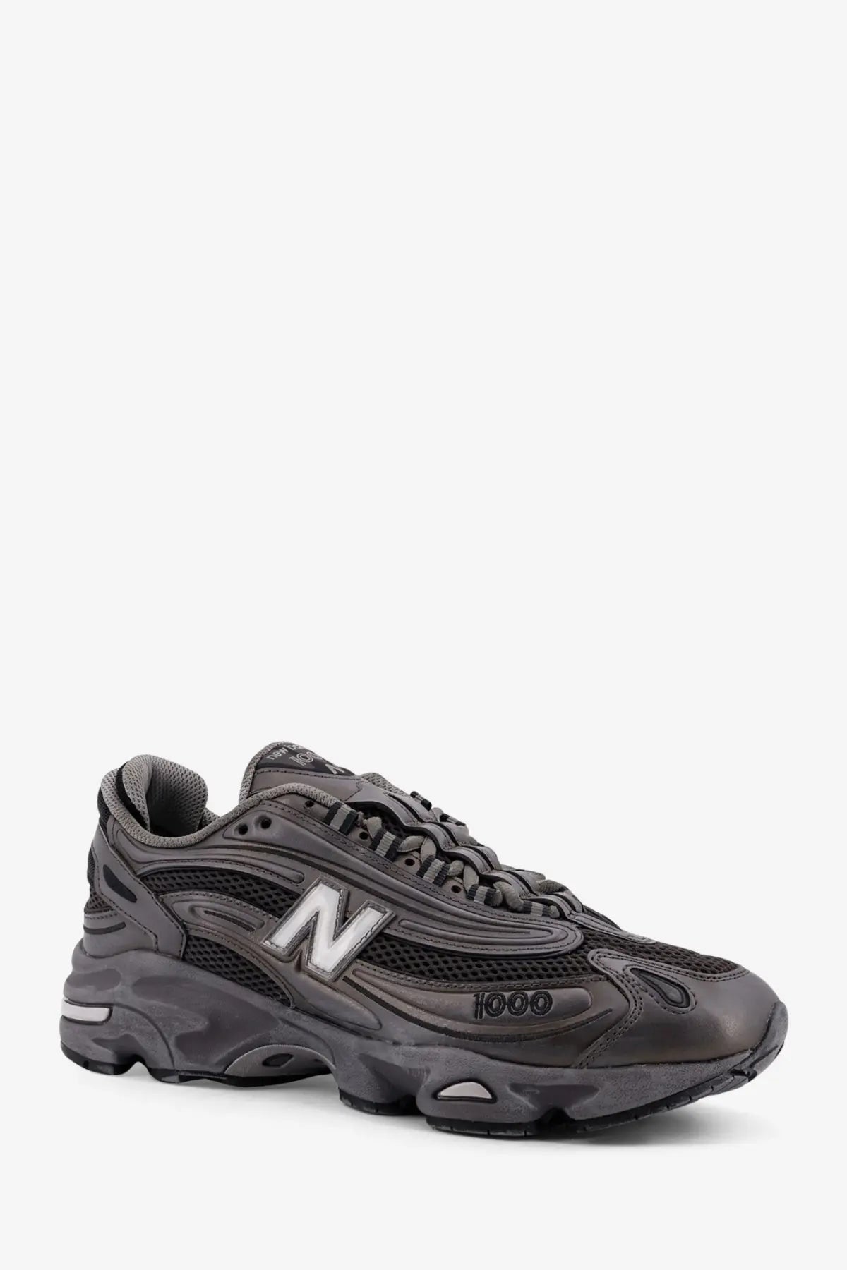 New Balance men’s low top mesh sneaker in dark gray with synthetic leather upper and white n logo on the side