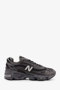 New Balance men’s low top mesh sneaker in dark gray with a chunky layered sole and breathable mesh upper