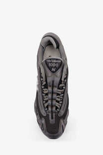 New Balance men’s low top mesh sneakers in gray with synthetic overlays for lightweight comfort and style