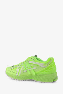 New Balance men’s low top mesh sneaker in vibrant neon green with white accents and a textured rubber sole